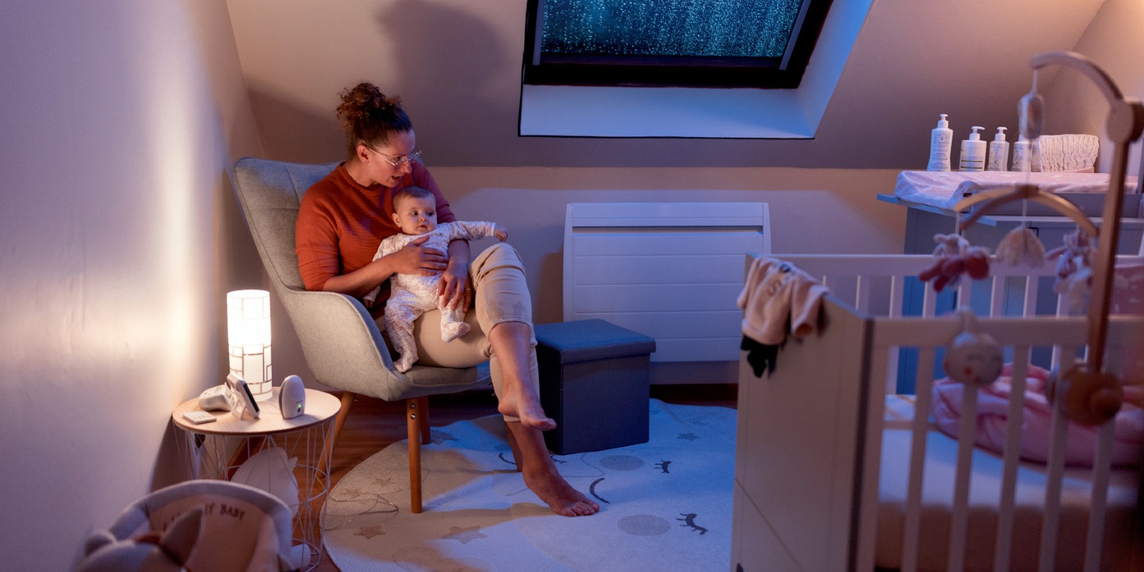 Mother holding baby in the nursery